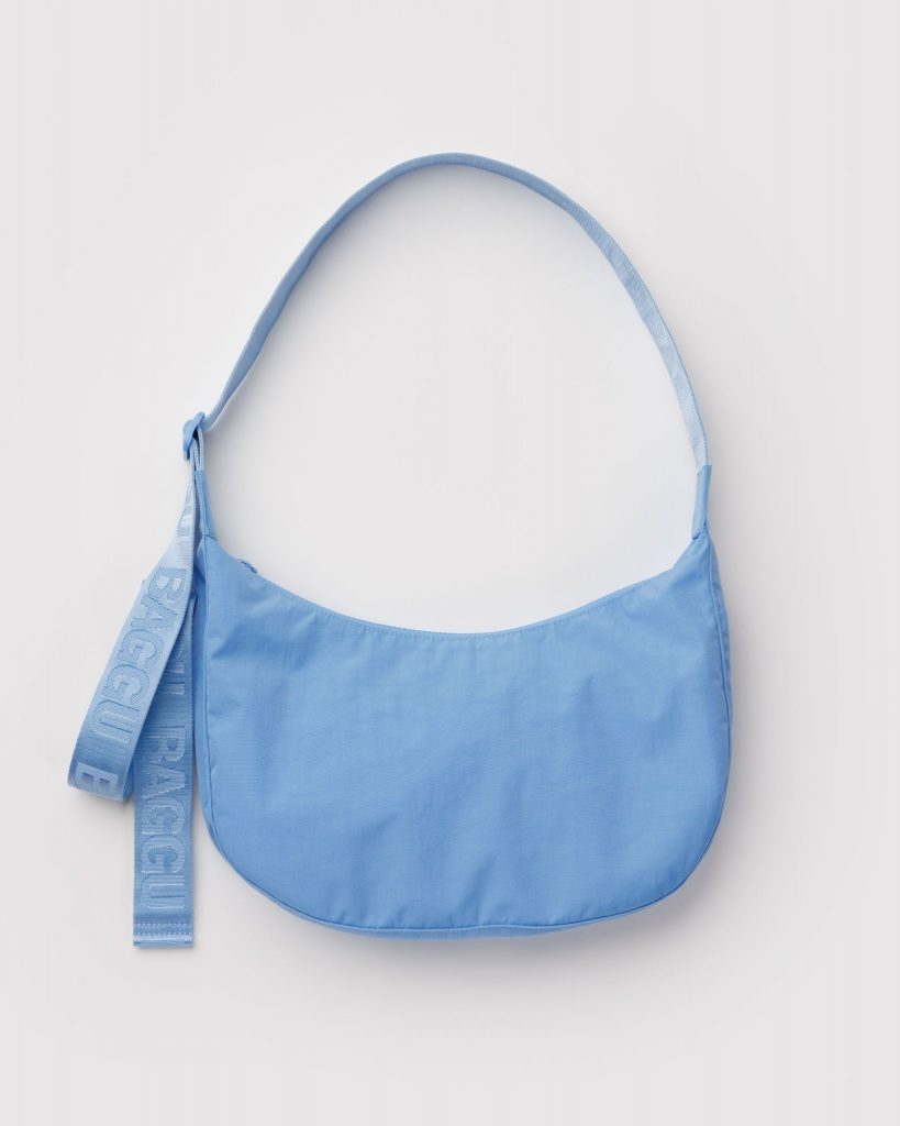 A light blue BAGGU shoulder bag with a unique strap.